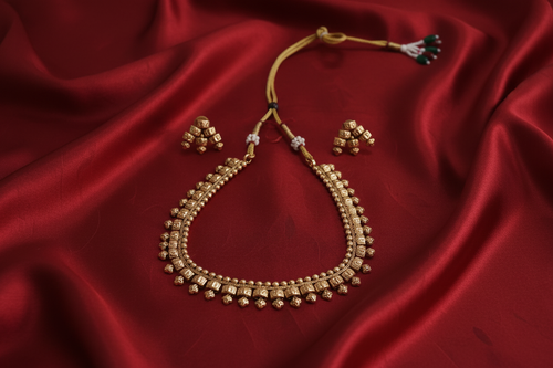 Antique Gold Ghungroo Necklace Set on Red Silk