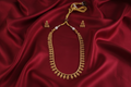Antique Gold Oval Leaf Necklace Set on Red Silk