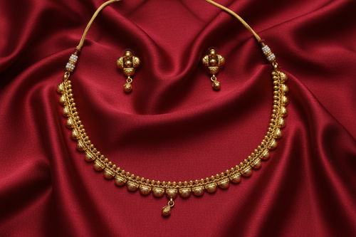 Gold Ball Chain Necklace Set on Red Silk