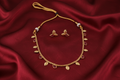 Gold Leaf & Ruby Red Stone Necklace Set on Red Silk