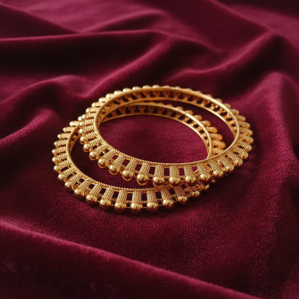 Gold-Tone Ghungroo Bangle Set on Burgundy Velvet