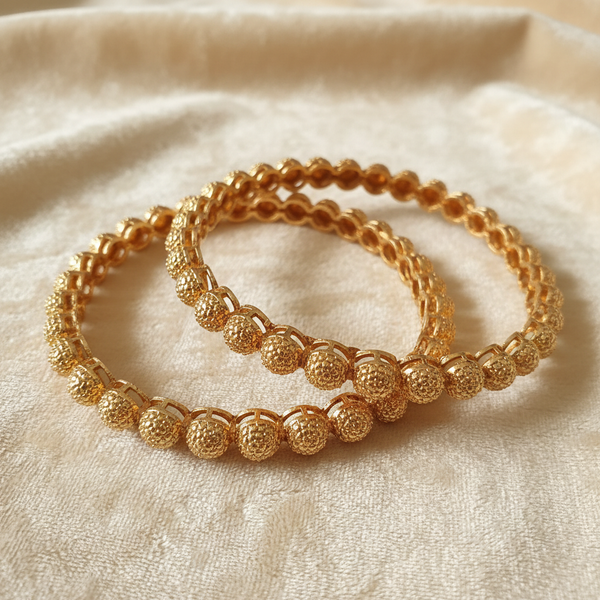 Gold-Tone Textured Ball Dome Bangle Set on Ivory Velvet
